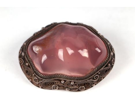 A Chinese silver metal brooch with large central polished quartz cabochon.
