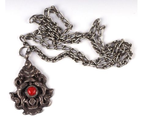 A Chinese cast silver pendant with various symbols.