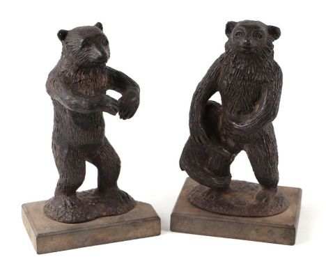 A 19th century bronze family of bears, mounted on slate bases, the largest 19cms high (2).Condition ReportThe slate base to t