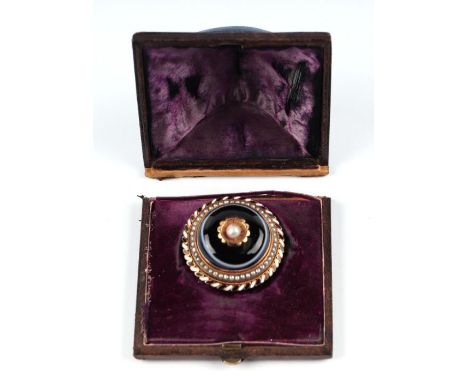 A Victorian yellow metal mounted pearl, agate and enamel mourning brooch, 4cms diameter, boxed.