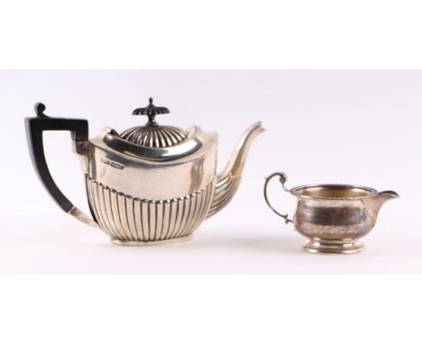 An Edwardian silver teapot, Sheffield 1903, 334g; together with a silver cream jug, Birmingham 1922, 100g (2).