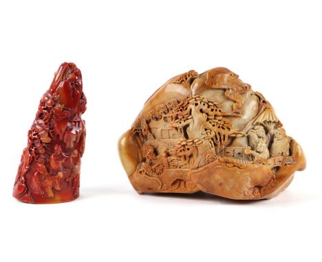A large Chinese soapstone boulder carving depicting figures in a landscape, 17cms wide; together with a similar tusk tip form