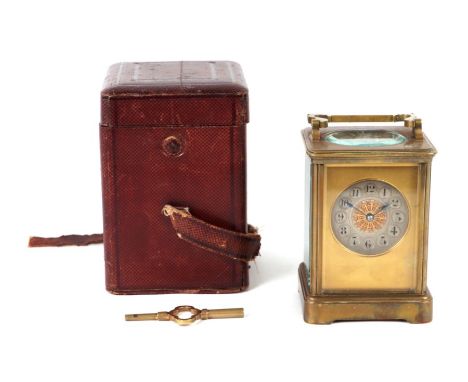 A brass cased carriage clock, the silvered dial with Arabic numerals, the movement striking on a gong, in original leather tr
