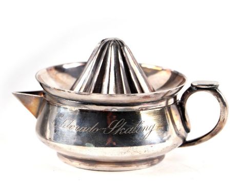 A silver plated lemon squeezer engraved 'Eldorado Skating', 9cms diameter.