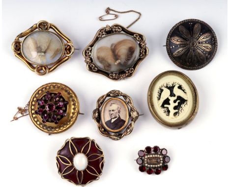A group of Victorian yellow metal mounted mourning brooches; together with a piquet work brooch and a yellow metal mounted op