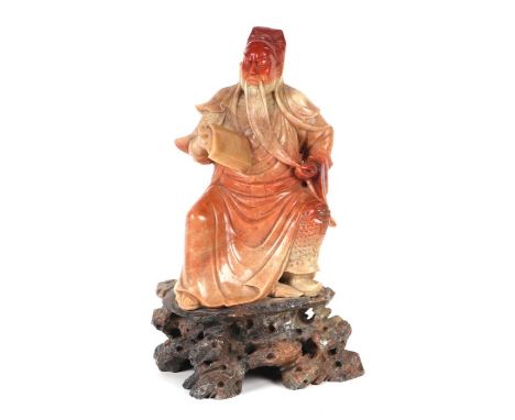 A large Chinese carved soapstone figure depicting Guan Yu, God of War, seated and holding a scroll, 30cms high.Condition Repo