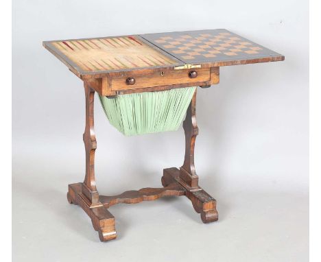 An early Victorian rosewood fold-over games and work table, the hinged top revealing backgammon and chessboard, the drawer wi