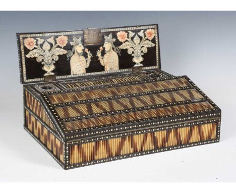 A 19th century Anglo-Indian ebony and porcupine quill inset writing box, inlaid with overall bone dots, the double-hinged lid