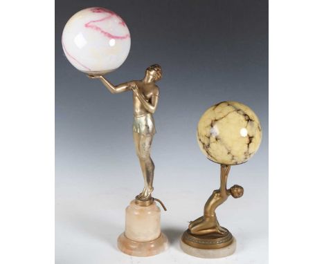 An Art Deco silvered cast spelter figural table lamp in the form of a standing lady holding a glass globe shade aloft, height