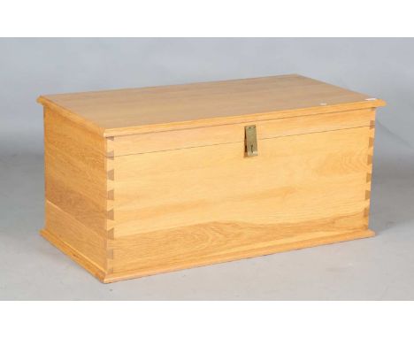 A modern solid oak trunk with brass clasp, height 50cm, width 107cm, depth 53cm.