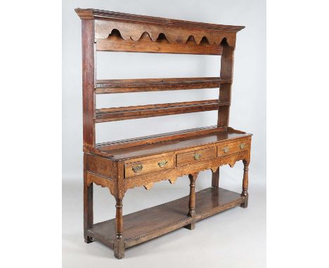 A George III provincial oak dresser, the later plate rack above three frieze drawers and a pot shelf, height 201cm, width 191