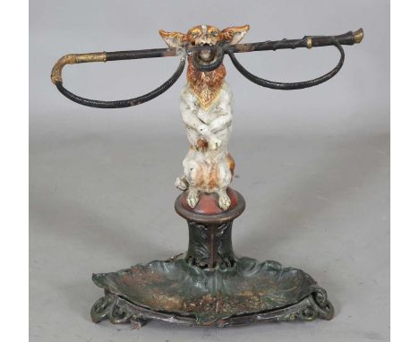 A 19th century cold painted cast iron stick and umbrella stand in the form of a begging dog holding a riding crop in it's mou