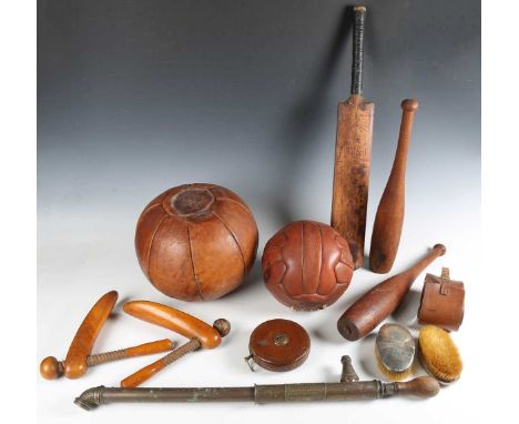 A group of vintage sports equipment, including a medicine ball, a lacrosse stick and two juggling skittles, together with a l