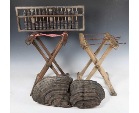 A 19th century Chinese wooden abacus, length 49cm, two Chinese folding stands and a decorative section of tree fungus, width 