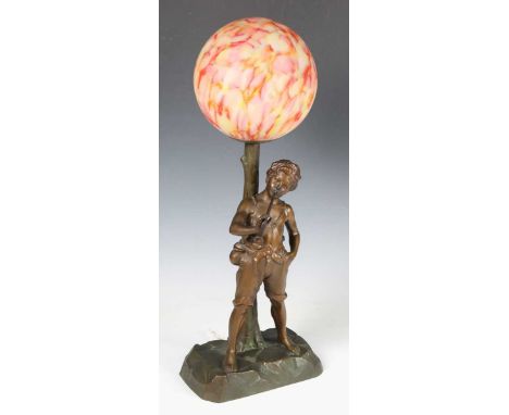 An early 20th century brown and gilt patinated cast spelter figural table lamp in the form of a boy playing a pipe, height 54