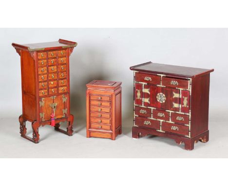 A modern Chinese stained softwood medicine chest, height 80cm, width 46cm, depth 26cm, together with a Chinese hardwood table