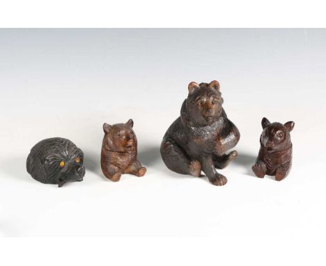 A late 19th century Black Forest carved softwood novelty inkwell, finely modelled as a seated bear, height 16cm, together wit