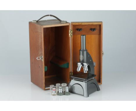 A Baker Microscope, English, c.1970, marked 'C. Baker 8830 London', finished in grey enamel with 5 objectives, in original wo