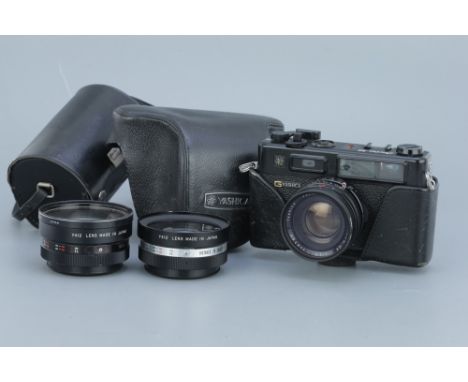 A Yashica Electro 35 Rangefinder Camera, black, with wide angle and telephoto auxiliary attachments, body, G, untested, lens,