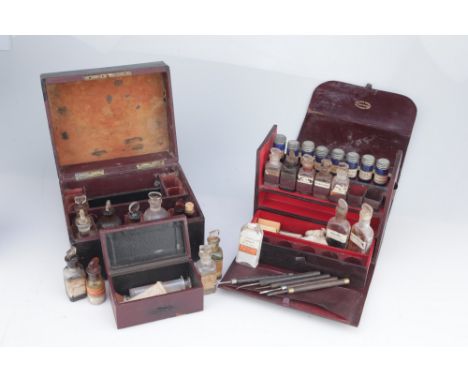 Two French Apothecary Chests, The first with fold down front and back, with drawer to the base, run of blue glass bottles in 