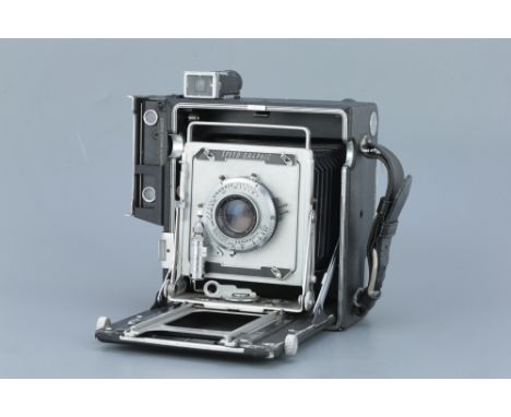 A Graflex Speed Graphic Large Format Press Camera, black, focal plane shutter working, with Kodak Ektar f/4.5 127mm lens, bod