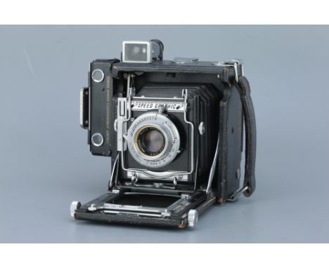 A Graflex Speed Graphic 6x9 Press Camera, black, with Kodak Ektar f/4.5 101mm lens and 6x9 roll film back, body, G-VG, focal 