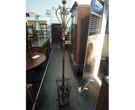 A metal copper effect coat and stick stand