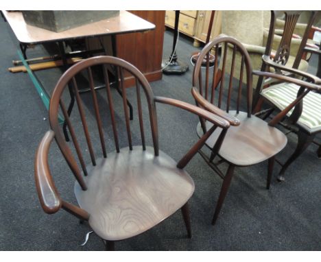 A pair of dark Ercol spindle back chairs