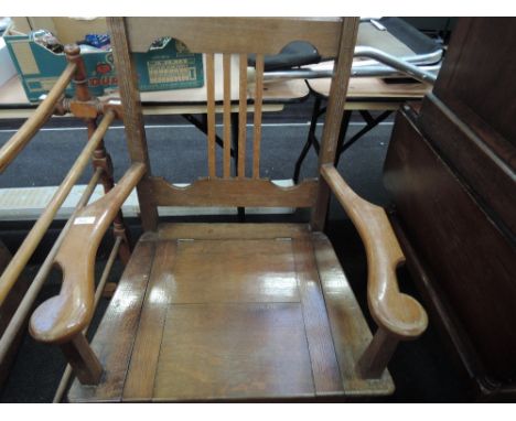 An Edwardian golden oak commode armchair
