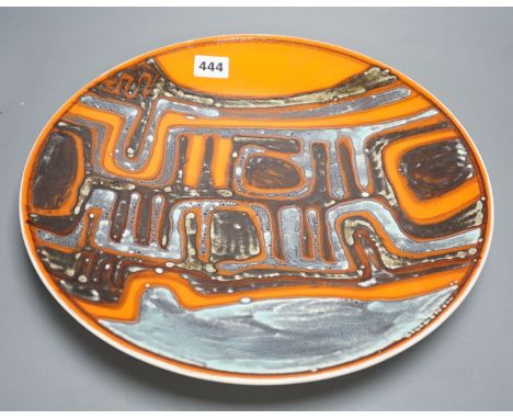 A Poole pottery orange Delphis designed charger-36 cms diameter.
