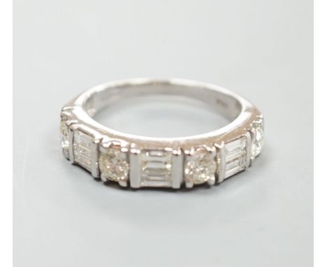 A modern 14ct gold, baguette and round cut diamond set half hoop ring, size K, gross weight 3.9 grams.