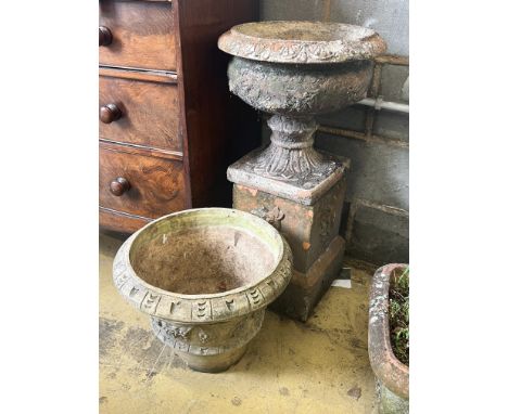 A terracotta campana garden urn on square plinth, height 77cm., together with a circular reconstituted stone garden planter