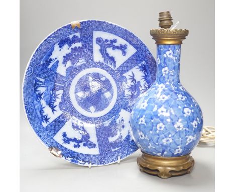 A Japanese prunus blue and white vase now as a lamp, together with a blue and white charger, 34cm diameter