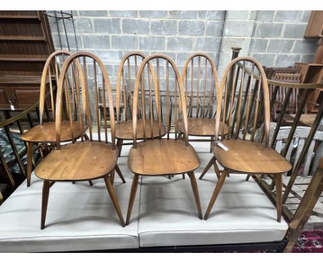 A set of six Ercol elm and beech comb back dining chairs