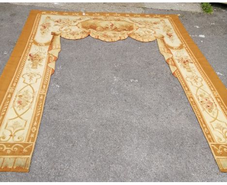 A French tapestry door surround woven with an octagonal vignette, floral swags and baskets of flowers, width 254cm height app