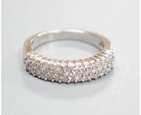 A modern 18ct white gold and three row diamond chip set half hoop ring, size K/L, gross weight 4.2 grams, total diamond weigh