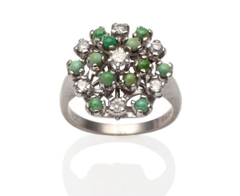 A diamond and turquoise cluster ring, a central round brilliant cut diamond, within a border of round cabochon turquoise and 