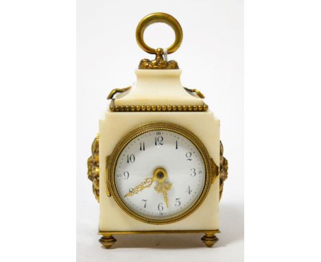 A white marble desk timepiece, circa 1910, loop handle and gilt metal mounts, enamel dial with Arabic numerals, single barrel