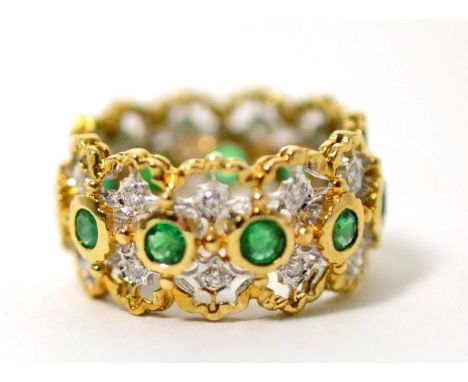 An emerald and diamond hoop ring, round cut emeralds in yellow rubbed over settings, spaced by pairs of round brilliant cut d