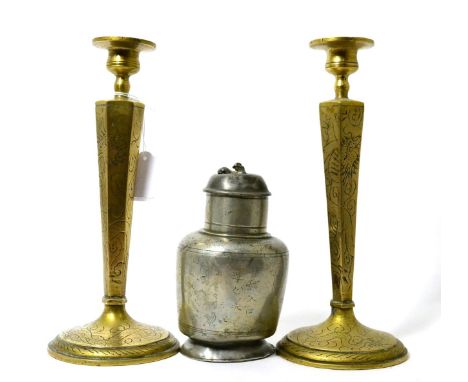 A Chinese pewter plum wine flask, Qing, 16cm high; and a pair of brass candlesticks with engraved decoration, 26cm high (3)  