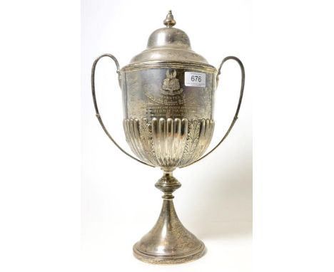 An Edwardian silver twin-handled trophy cup, Sheffield 1902, with presentation inscription and repousse with a hunting scene 