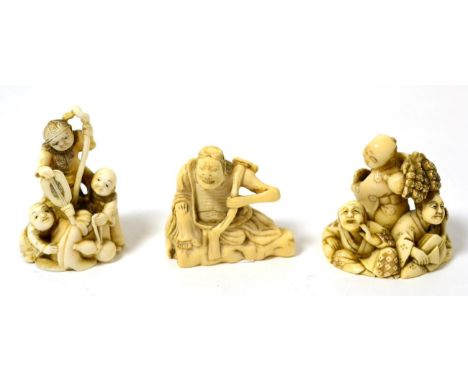 A Japanese ivory netsuke as children holding a fan, 5cm; a similar as a group of children with a shamisen, 4.5cm; and another