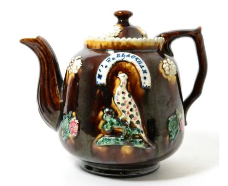 A Measham bargeware teapot and cover, inscribed M W BLACKHAM, PETERBOROUGH 1873, 19cm high      