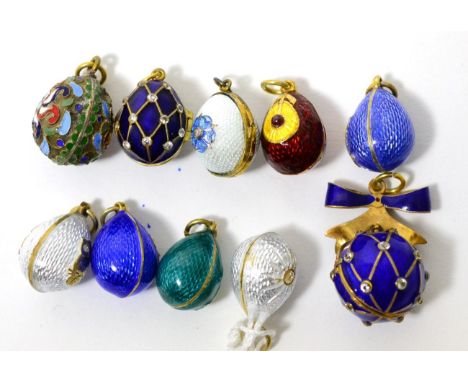 Nine egg charms and an ball charm, enamelled in various colours and some hinged to open      Good condition overall. Some min