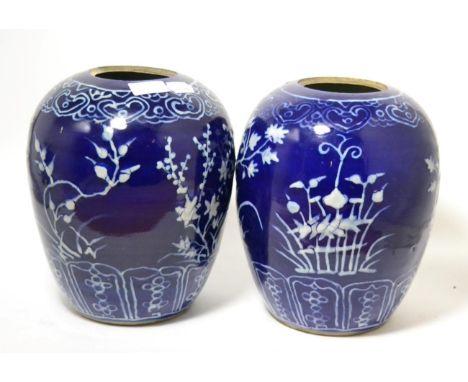 A pair of Chinese blue ground porcelain jars, Qing Dynasty, painted in white enamel for the Persian market with stylised flow