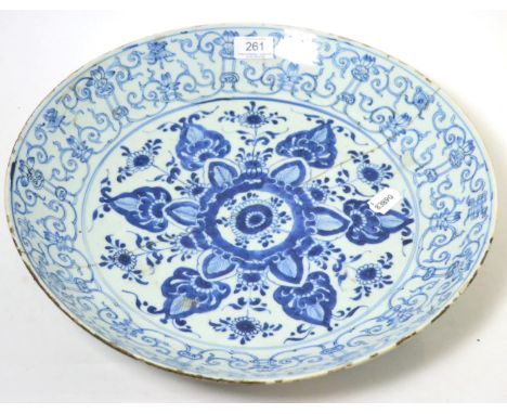 A Chinese porcelain saucer dish, Kangxi, painted in underglaze blue with foliage within a leaf scroll border, 40cm diameter (