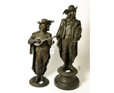 A pair of spelter figures of Renaissance musicians, late 19th century, standing holding a lute and violin, on circular bases,