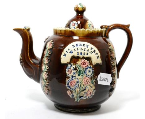 A Measham bargeware teapot and cover, inscribed MRS BERRY FROM WILLIAM 1889, 20cm high      