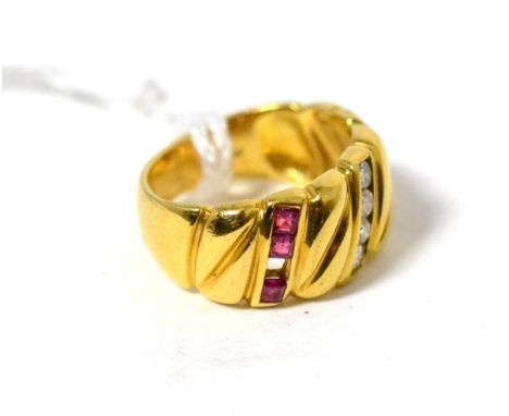 A ruby and diamond ring, four round brilliant cut diamonds between step cut rubies in yellow channel settings to the fancy sc