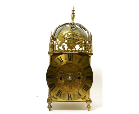 A brass lantern clock, circa 1900, four posted case with pierced frets, engraved side door panels, 6-1/2-inch Roman numeral c